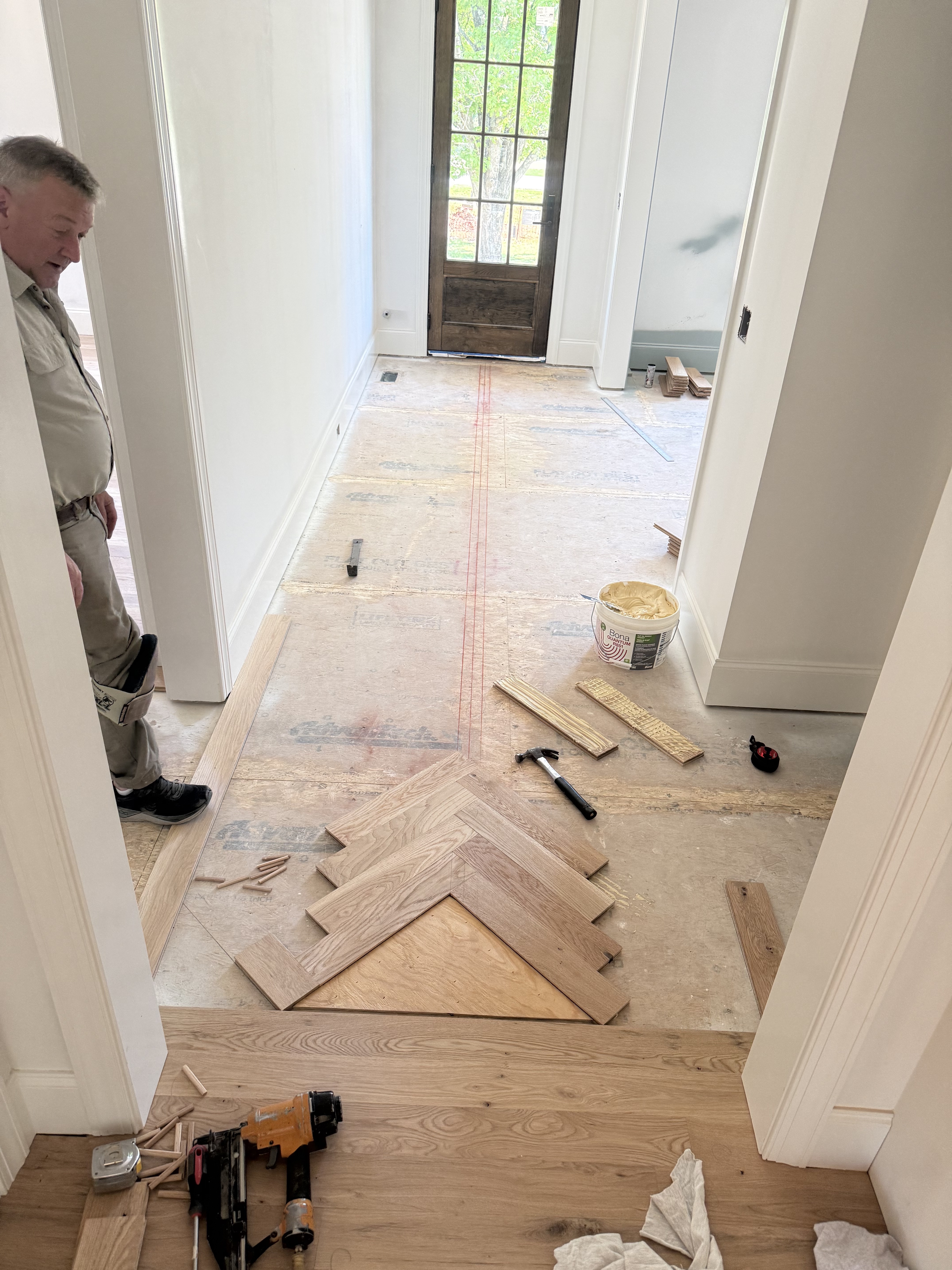 Herringbone flooring installation in progress, step 1 of 3