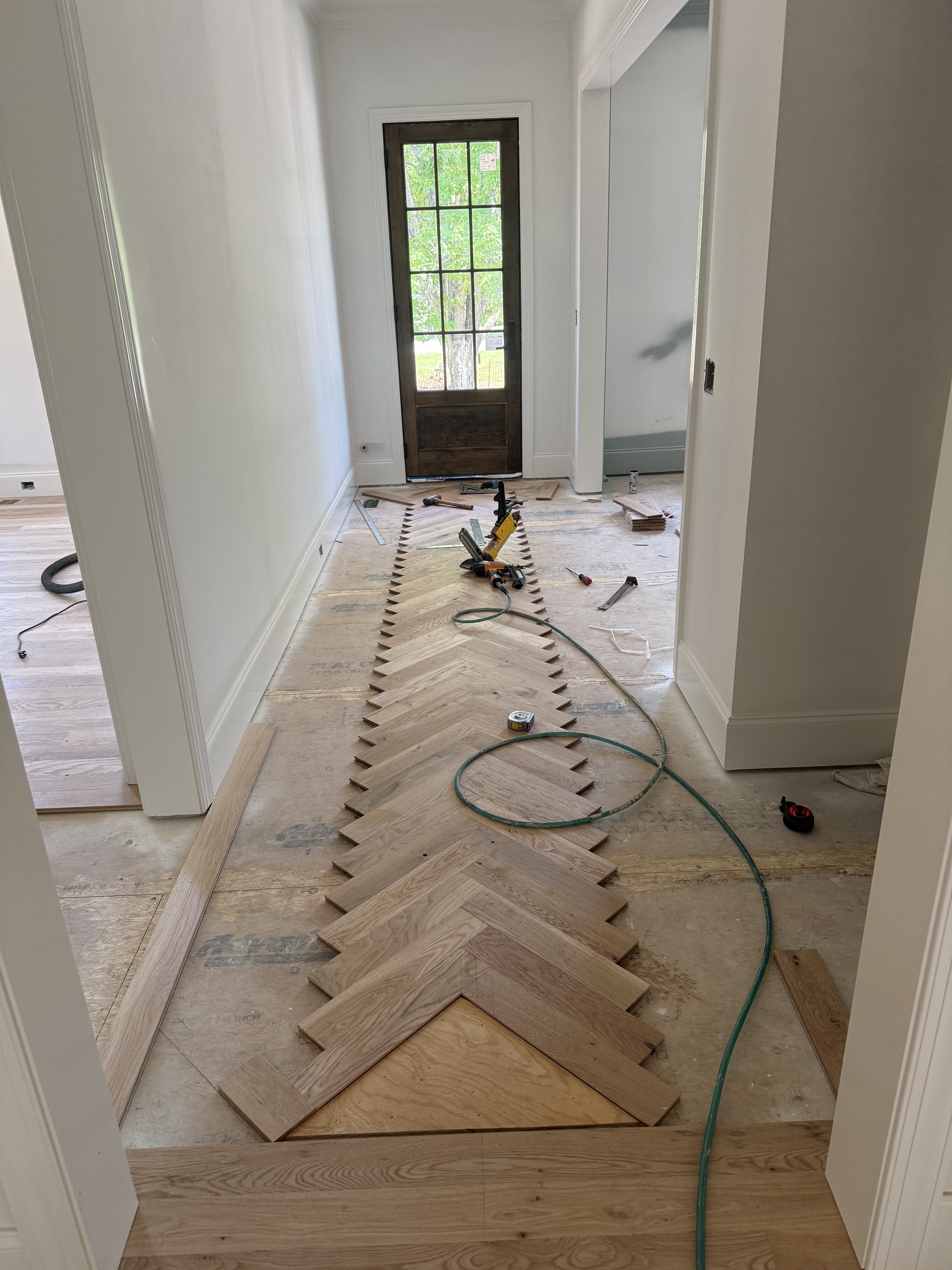Herringbone flooring installation in progress, step 2 of 3