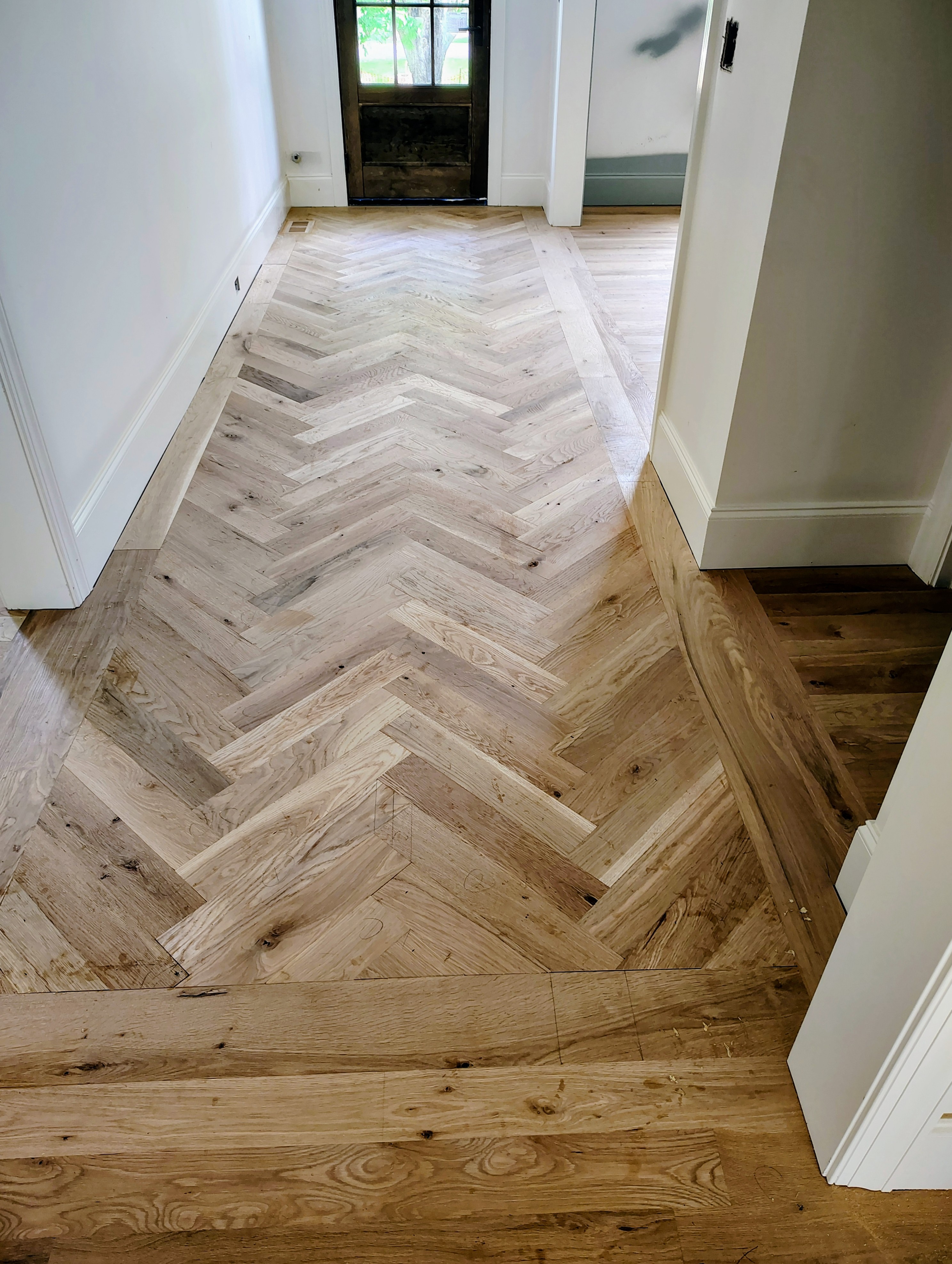 Completed herringbone flooring installation, step 3 of 3